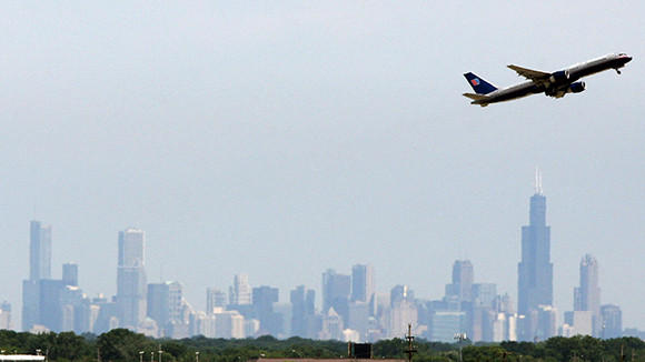United Airlines Jet Takes Off With The Chicago Skyline In Background