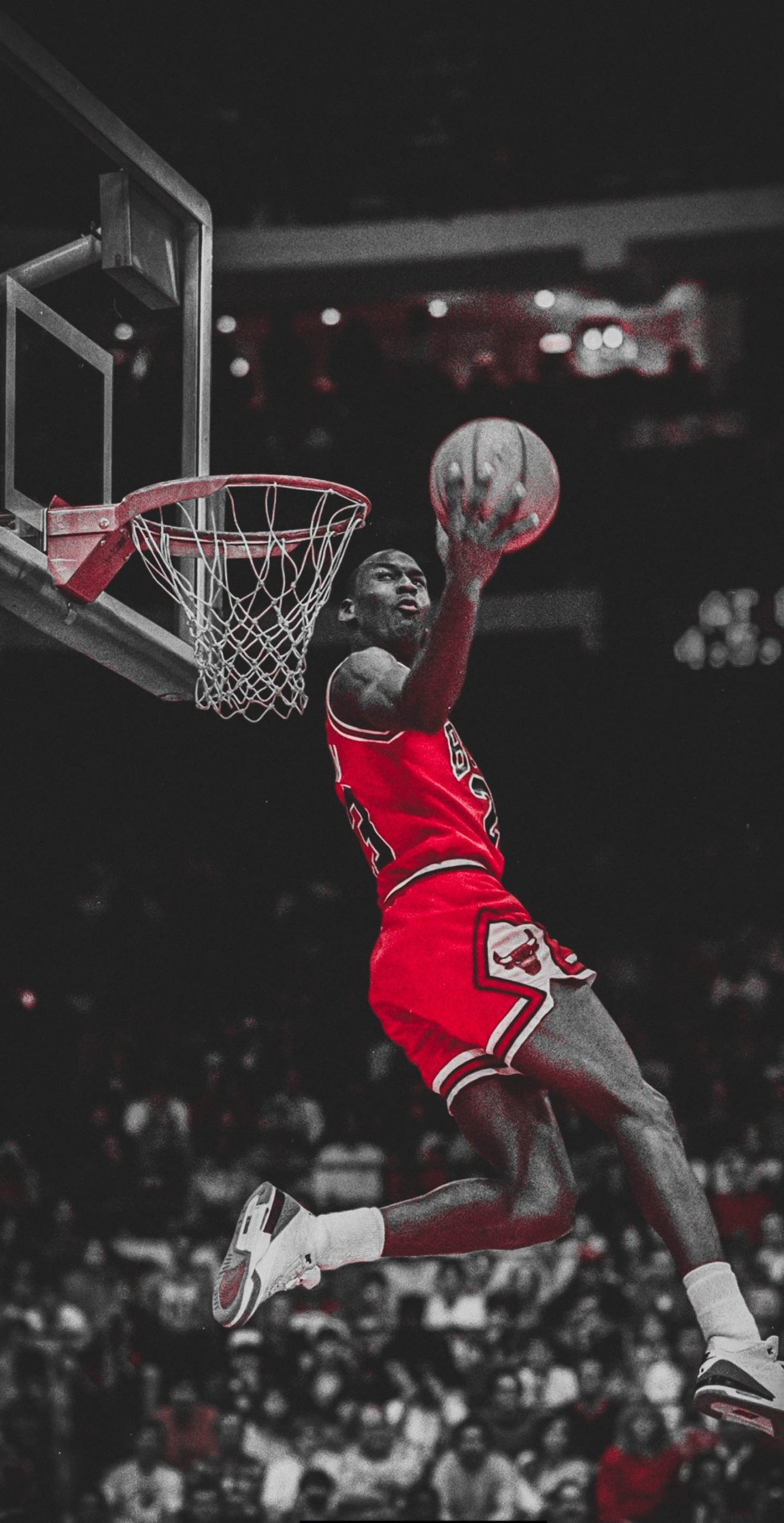 Michael Jordan soaring through the air for a dunk in a Chicago Bulls game, showcasing his iconic athleticism and skill