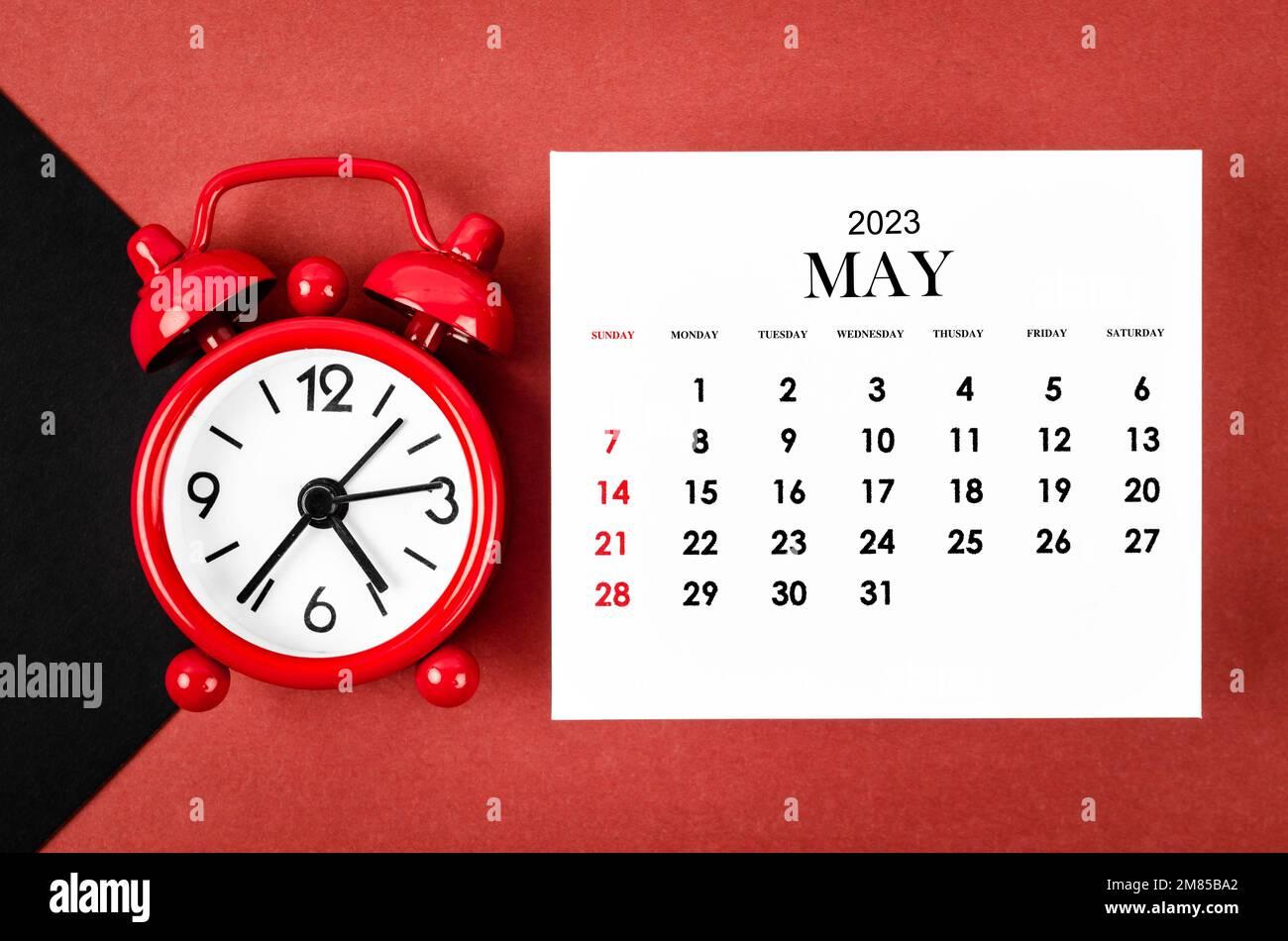 May 2023 Monthly calendar year with alarm clock on red and black