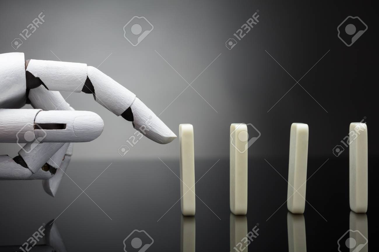 Robotic Hand Pushing Dominos On Grey Background Stock Photo