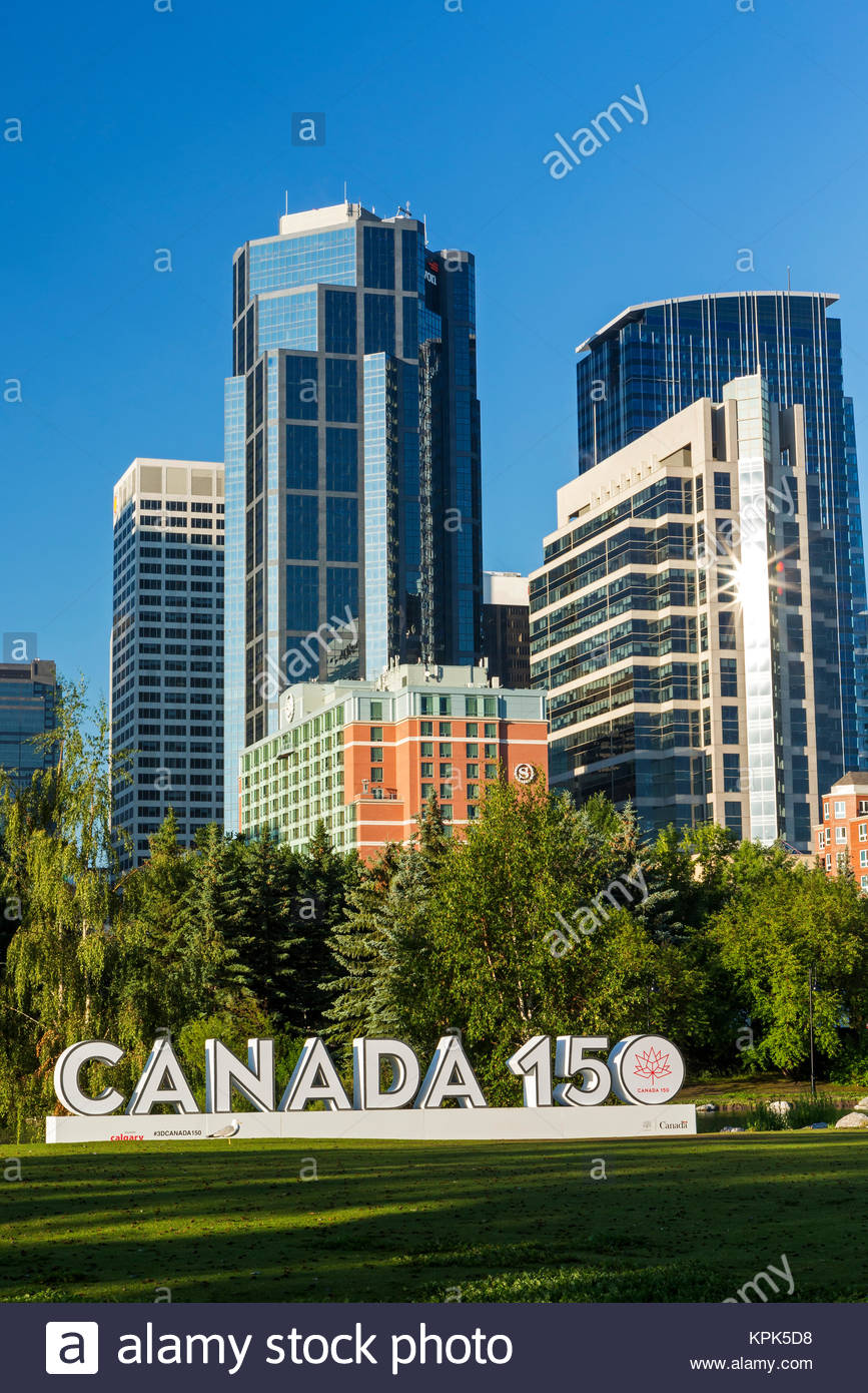 Canada 150 signage in city park with Calgary building towers in