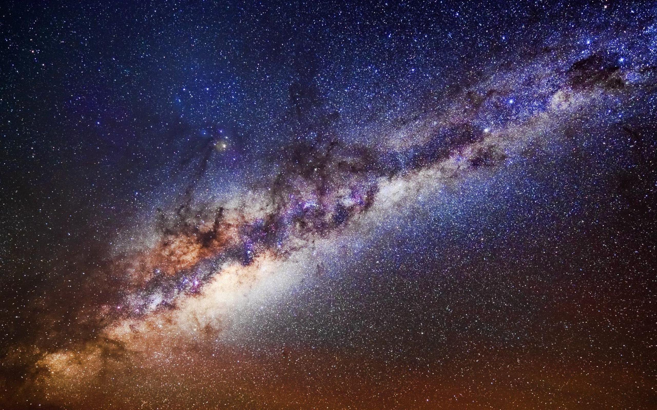 A breathtaking view of the Milky Way galaxy stretching across a dark, star-studded sky