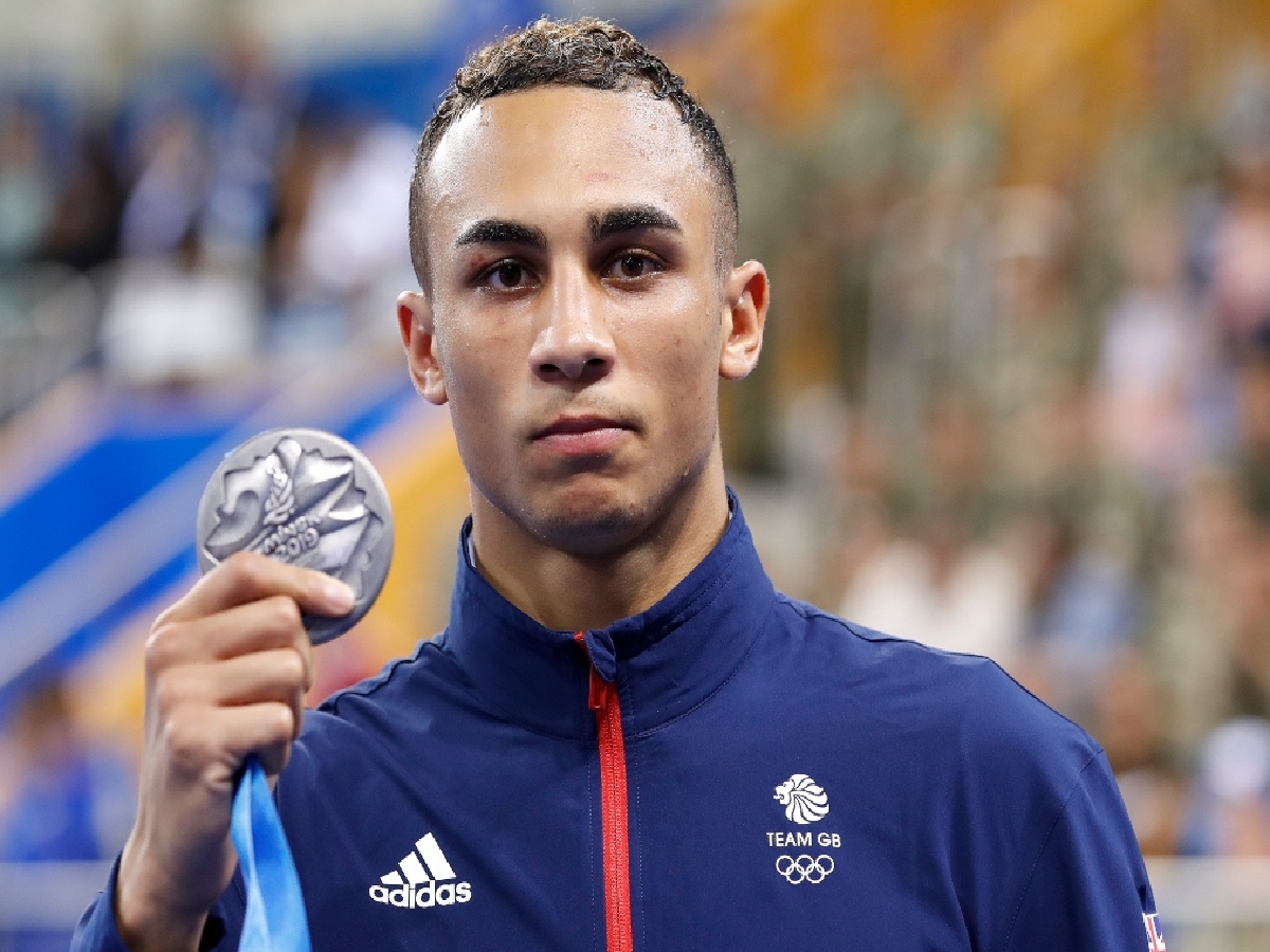 Benjamin Whittaker proudly displays his silver medal at a sporting event