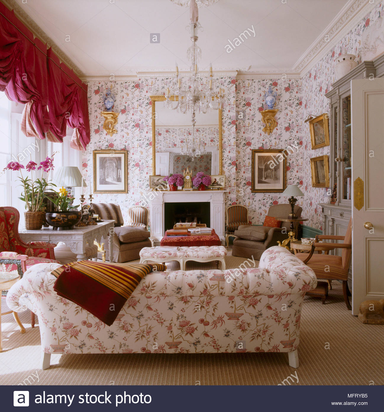 A Grand Traditional Sitting Room With Fireplace Red Floral