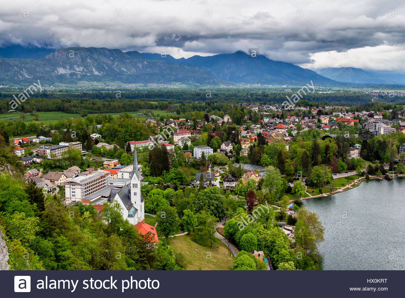 Aerial Of Bled City With Alps Mountains In The Background