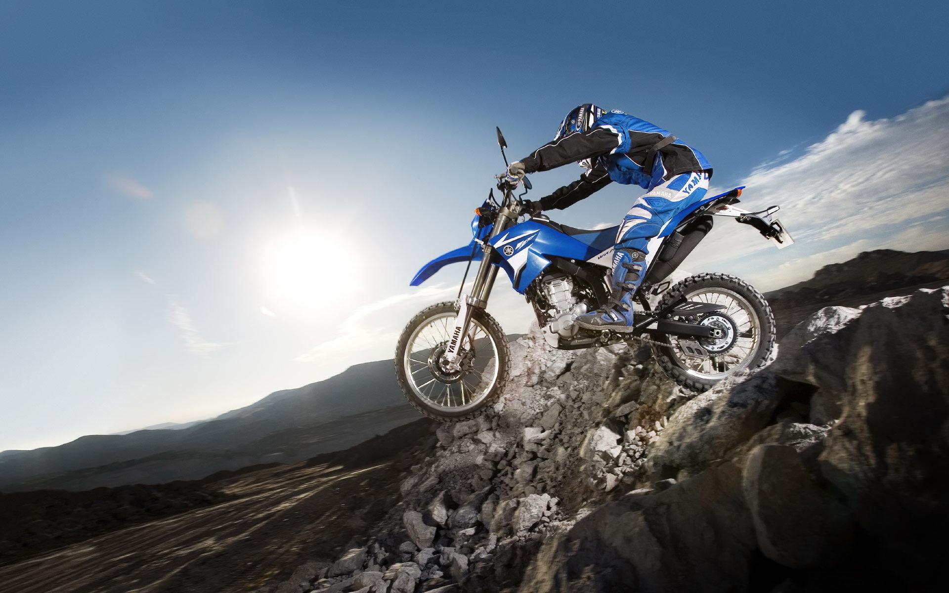 Wallpaper Man Riding Motocross Dirt Bike on Brown Sand Background   Download Free Image