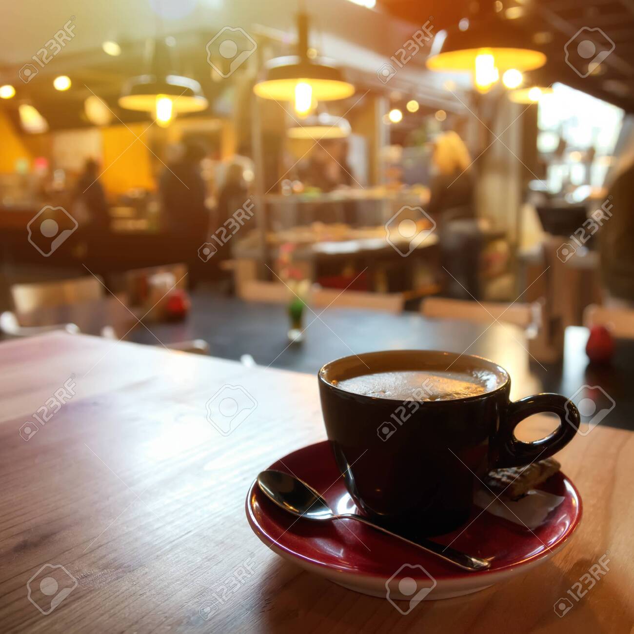 Coffee Cup On Wooden Table With Blur Shop Background