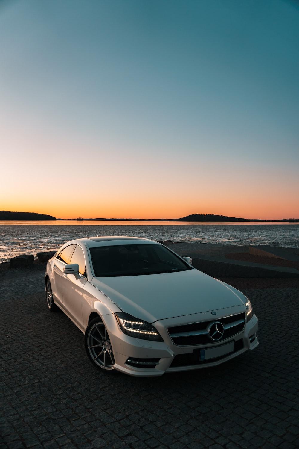 White Mercedes Benz C Class On Beach During Sunset Photo