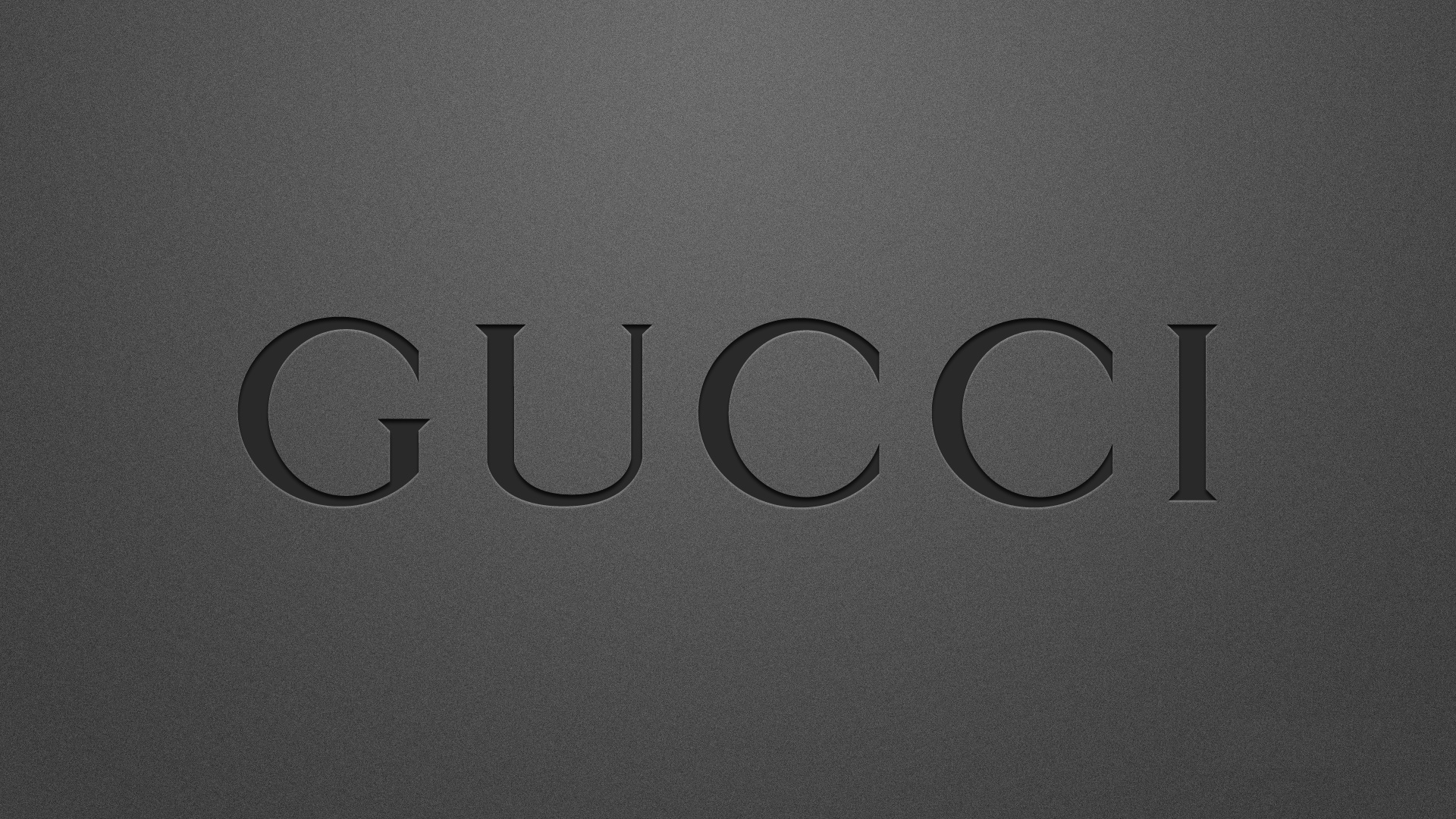 Gucci logo on a dark gray textured background