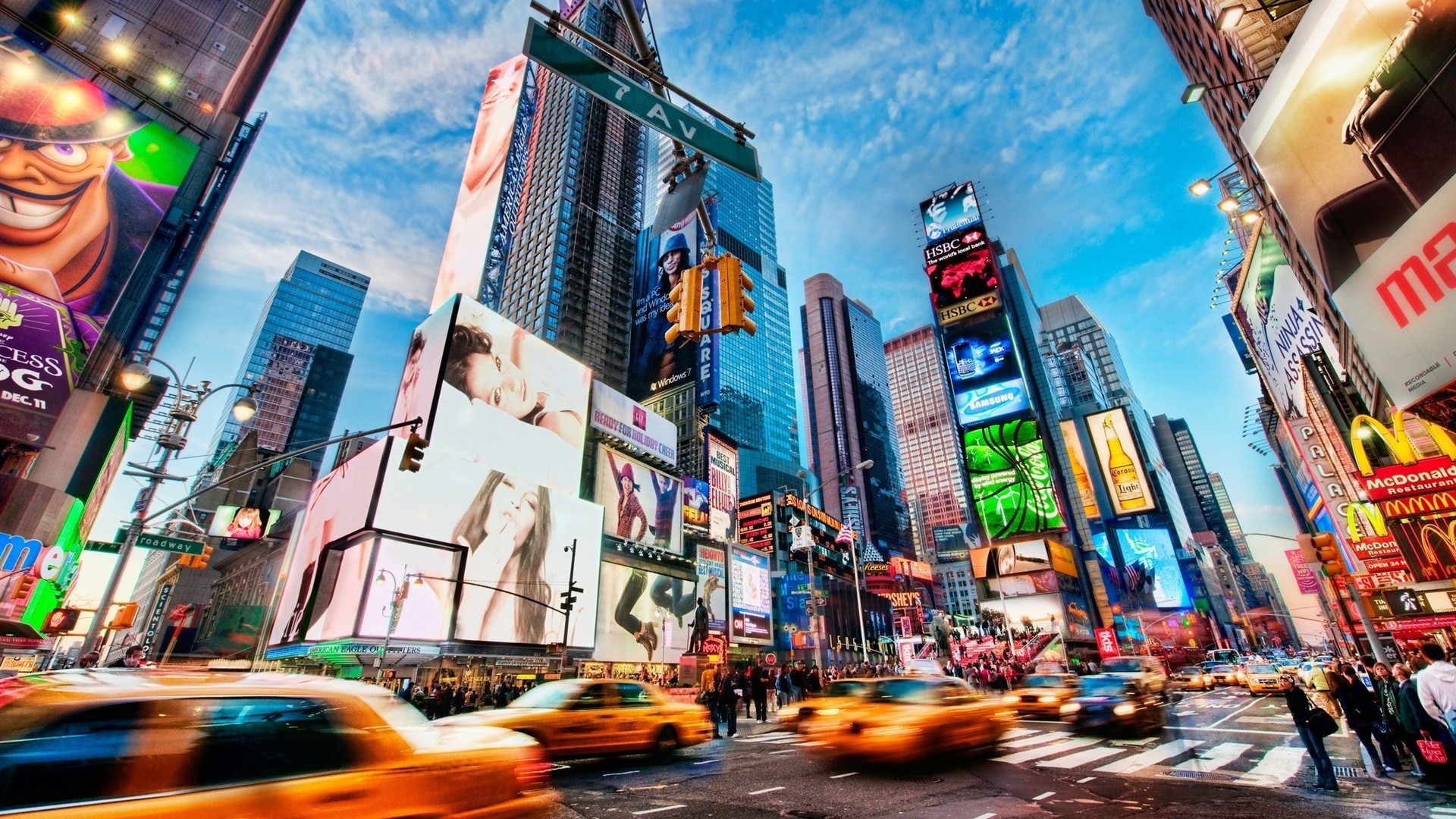 A vibrant long-exposure photo of Times Square at twilight, showcasing the dazzling lights of Broadway and the iconic yellow cabs in motion