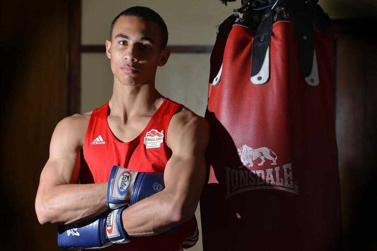 Benjamin Whittaker, English boxer, poses with arms crossed in front of a punching bag