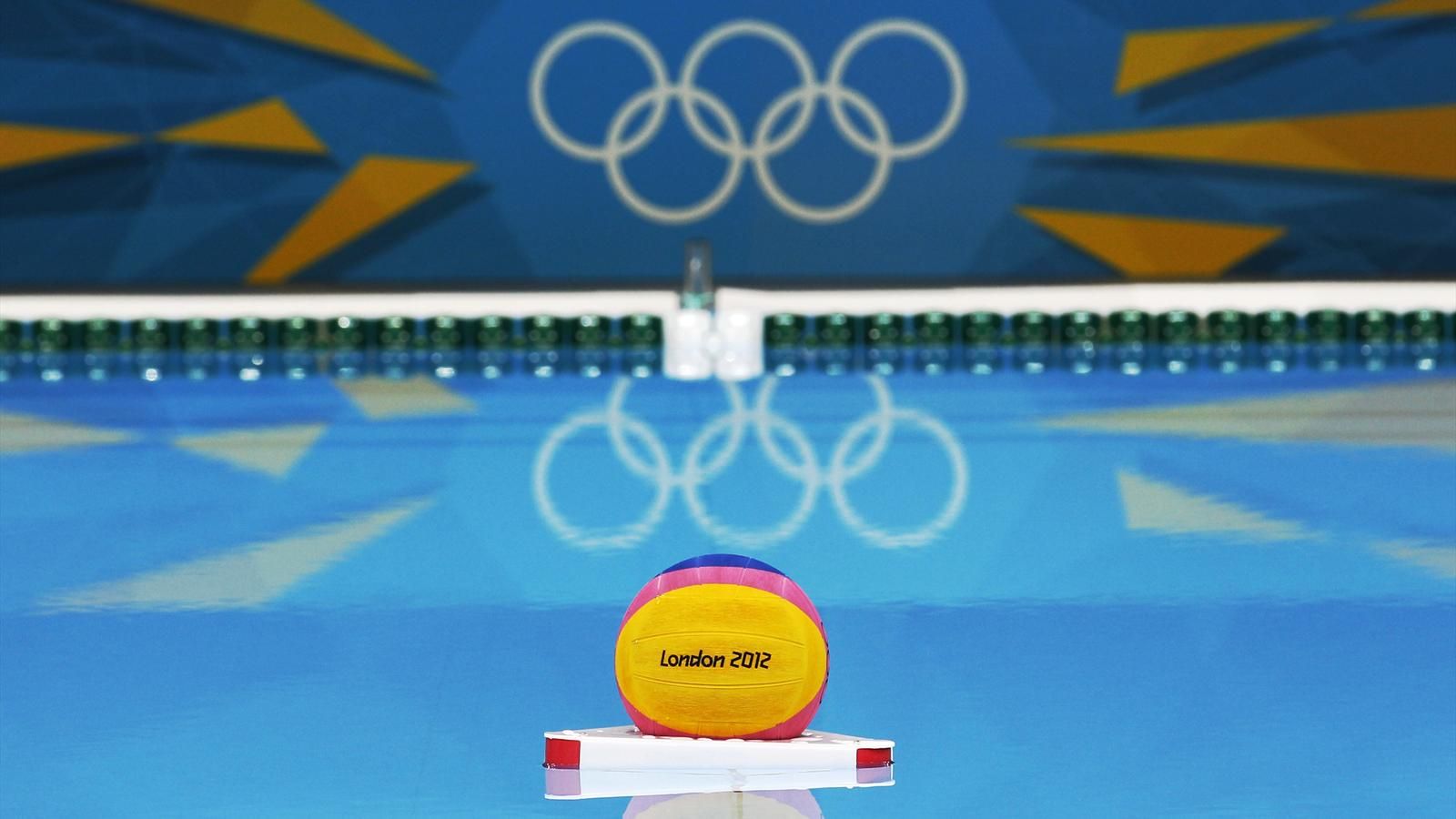 Water Polo Ball Floats In Front Of The Olympic Rings At
