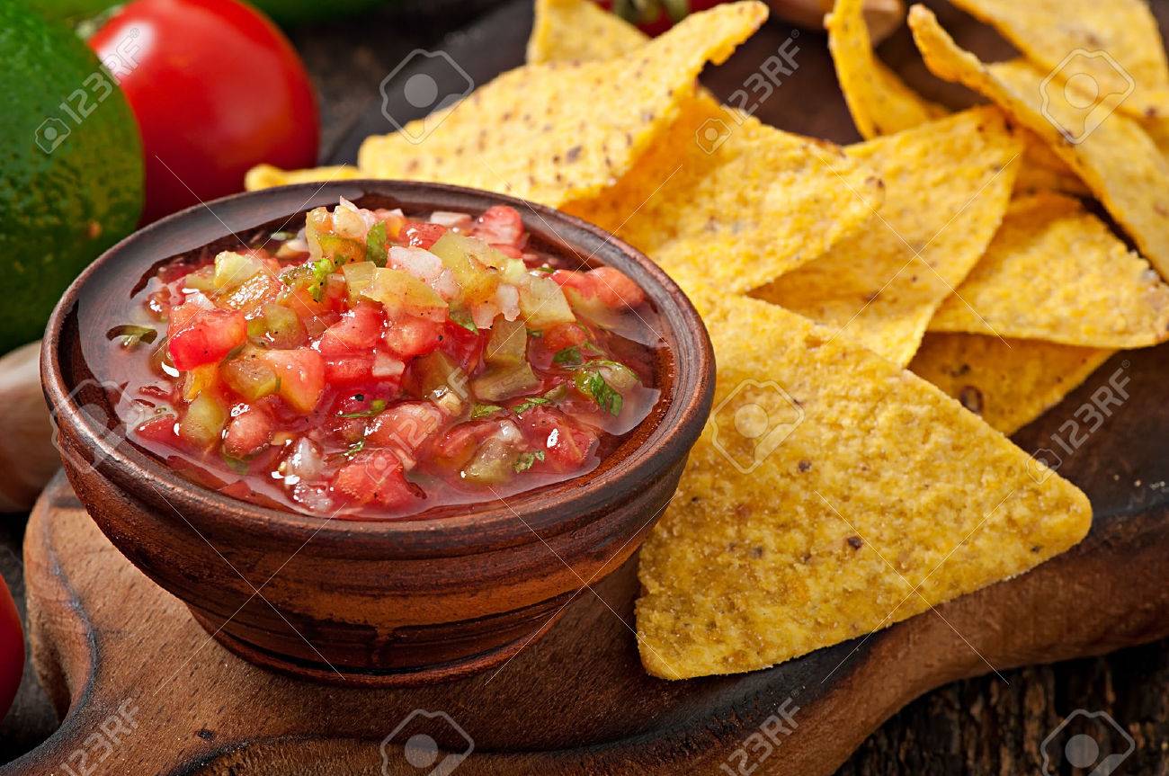 Mexican Nacho Chips And Salsa Dip In Bowl On Wooden Background