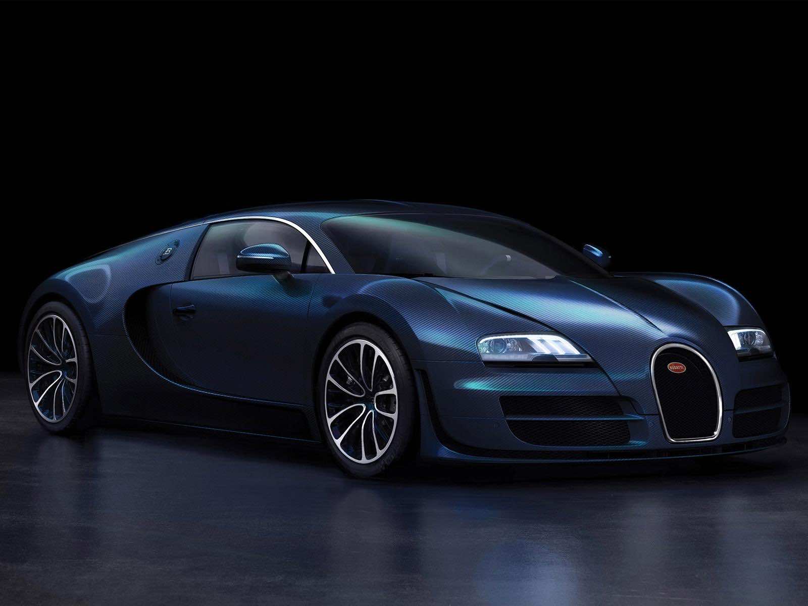 A sleek, dark blue Bugatti Veyron sports car, gleaming under studio lights. Its carbon fiber body and signature horseshoe grille are prominent, showcasing the car's luxurious design and high performance