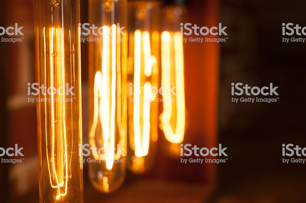 Light Bulb Lamp On Dark Red Brick Background With Hotspot Close Up
