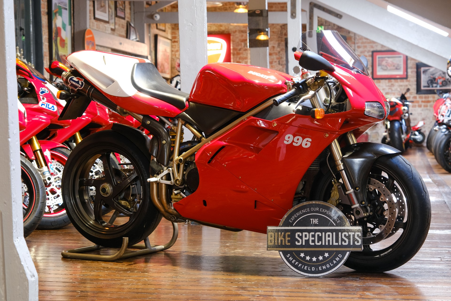 Ducati 996 sportbike in a showroom, showcasing its iconic design and red color