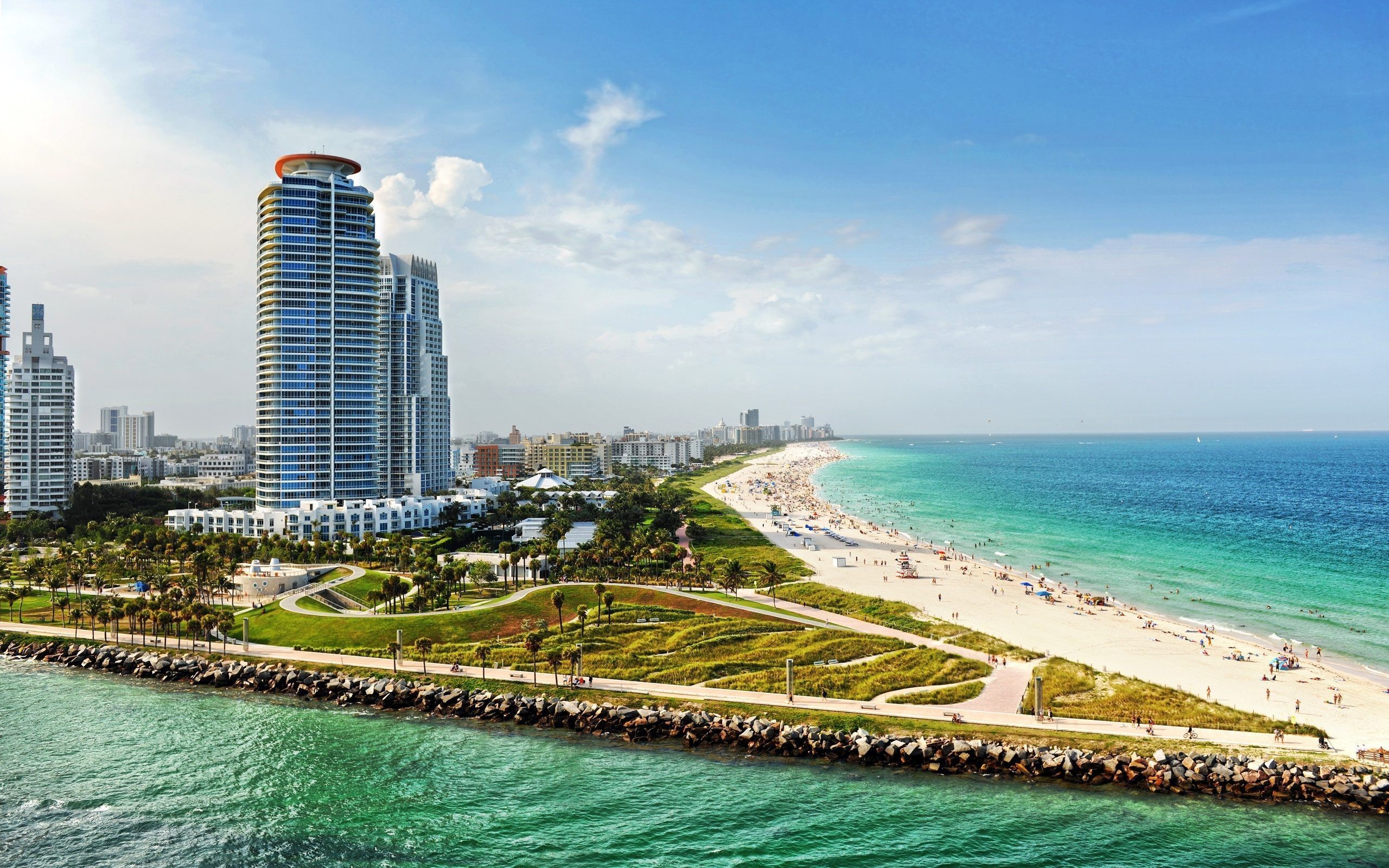 Scenic view of South Pointe Park Beach in Miami, Florida, featuring turquoise waters, white sand, and modern high-rise buildings