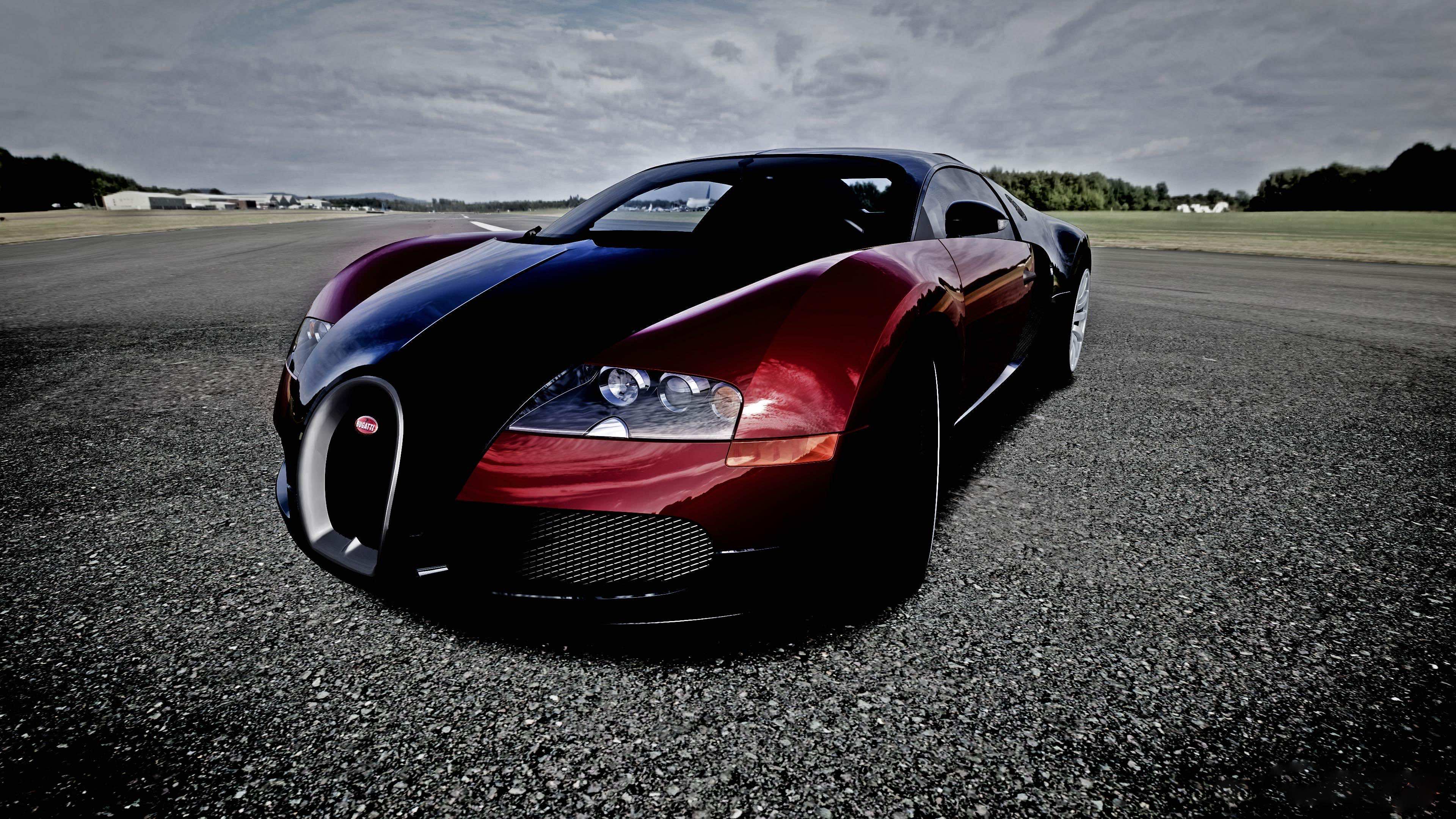 A two-toned Bugatti Veyron parked on an asphalt surface, showcasing its sleek design and powerful presence