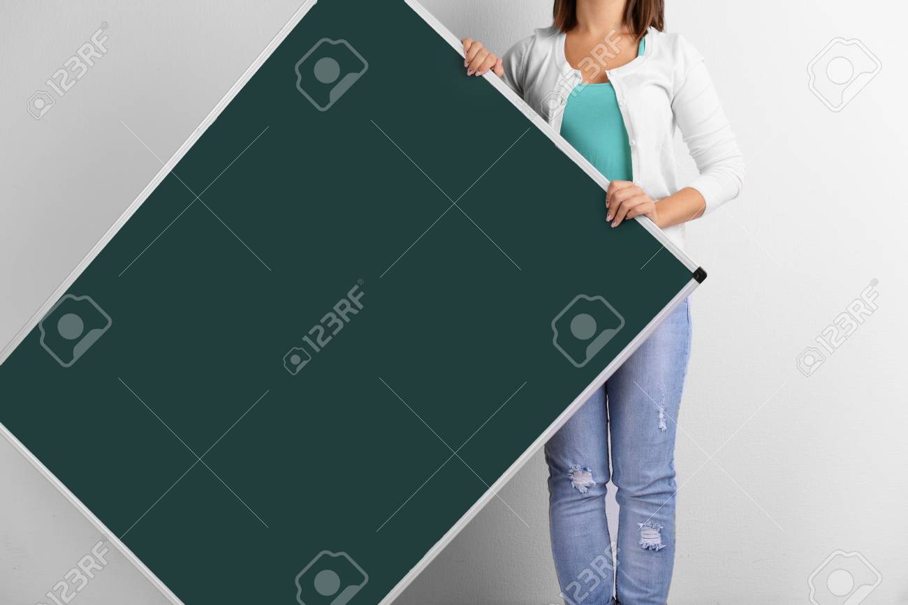 Woman In Causal With Green Blackboard On Grey Background Close