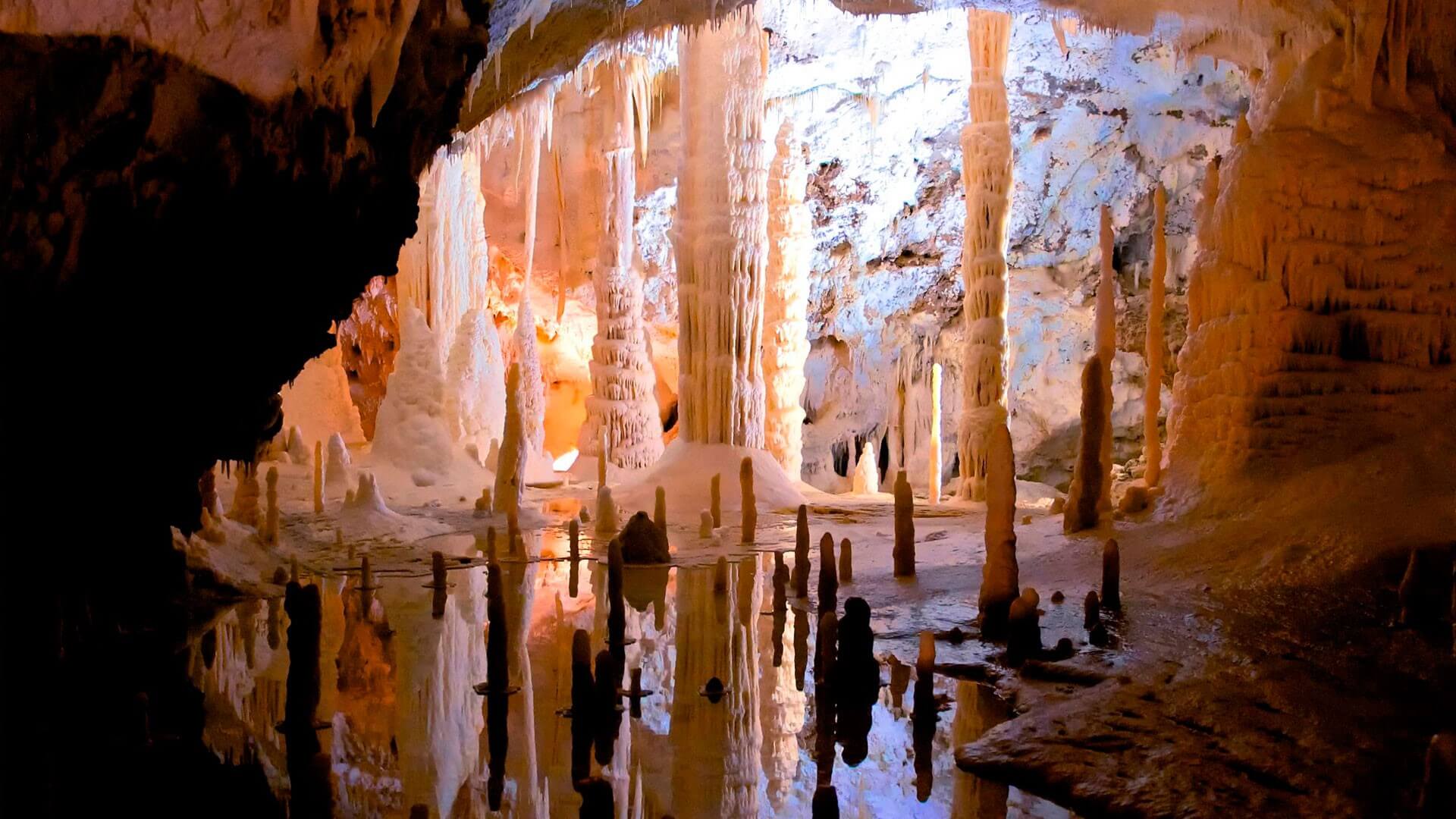Spectacular cave formations reflected in a still pool of water