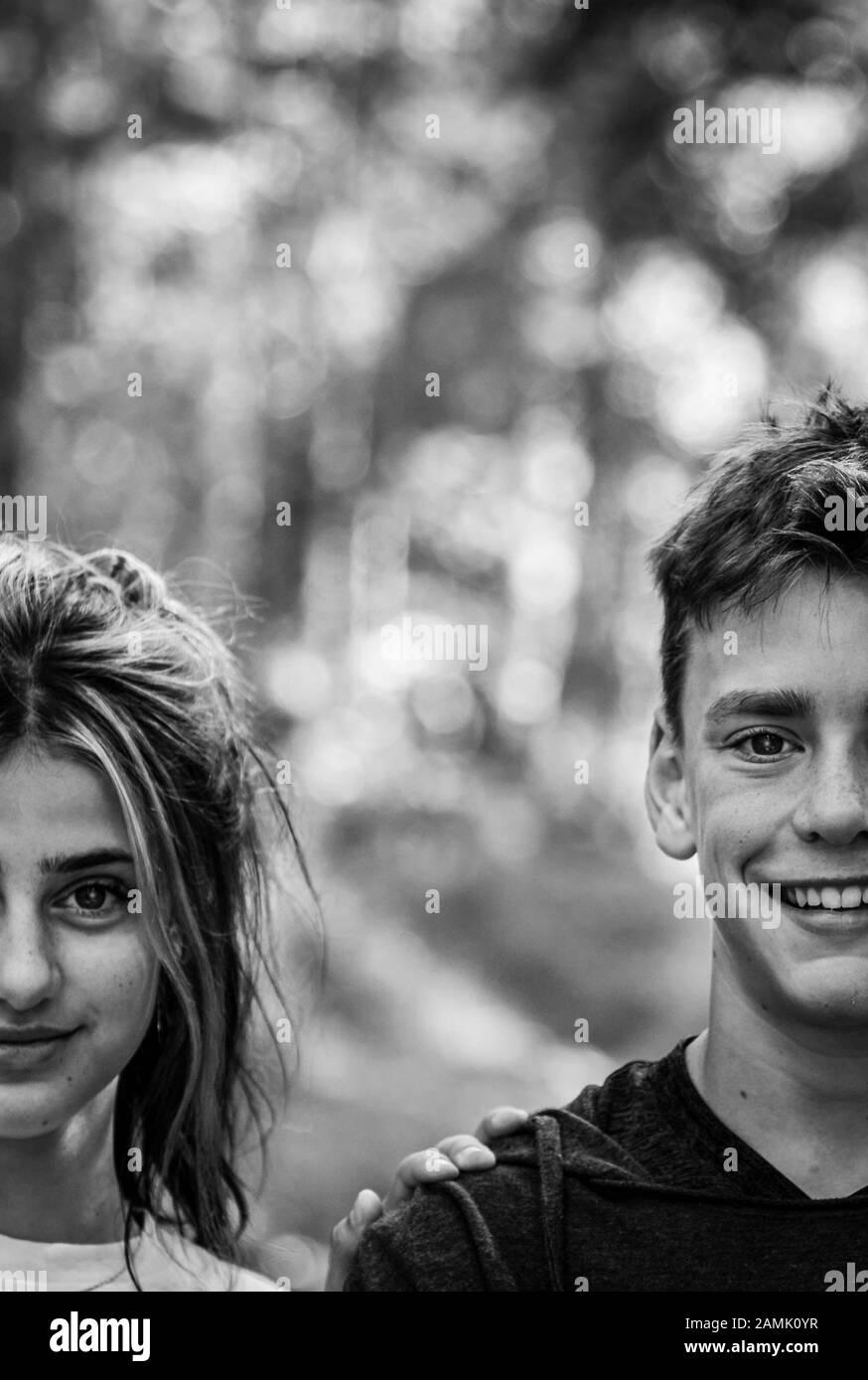 Black and white creative portrait of teen boy and girl brother