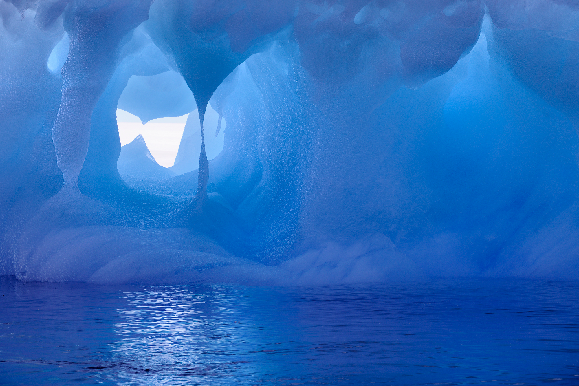 Mesmerizing Ice Cave: A breathtaking view inside a naturally formed ice cave with vibrant blue hues and intricate ice formations