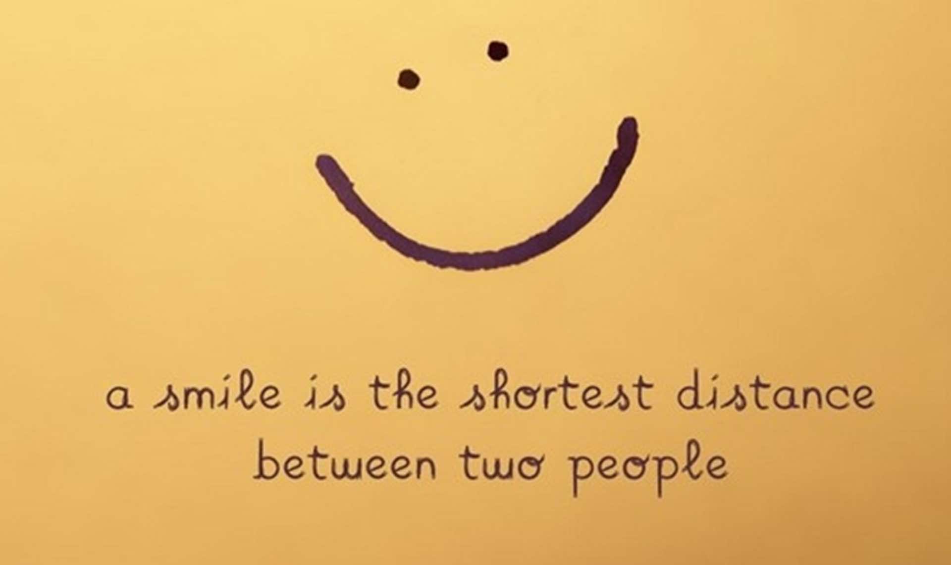 A simple smiley face with the quote 'A smile is the shortest distance between two people'