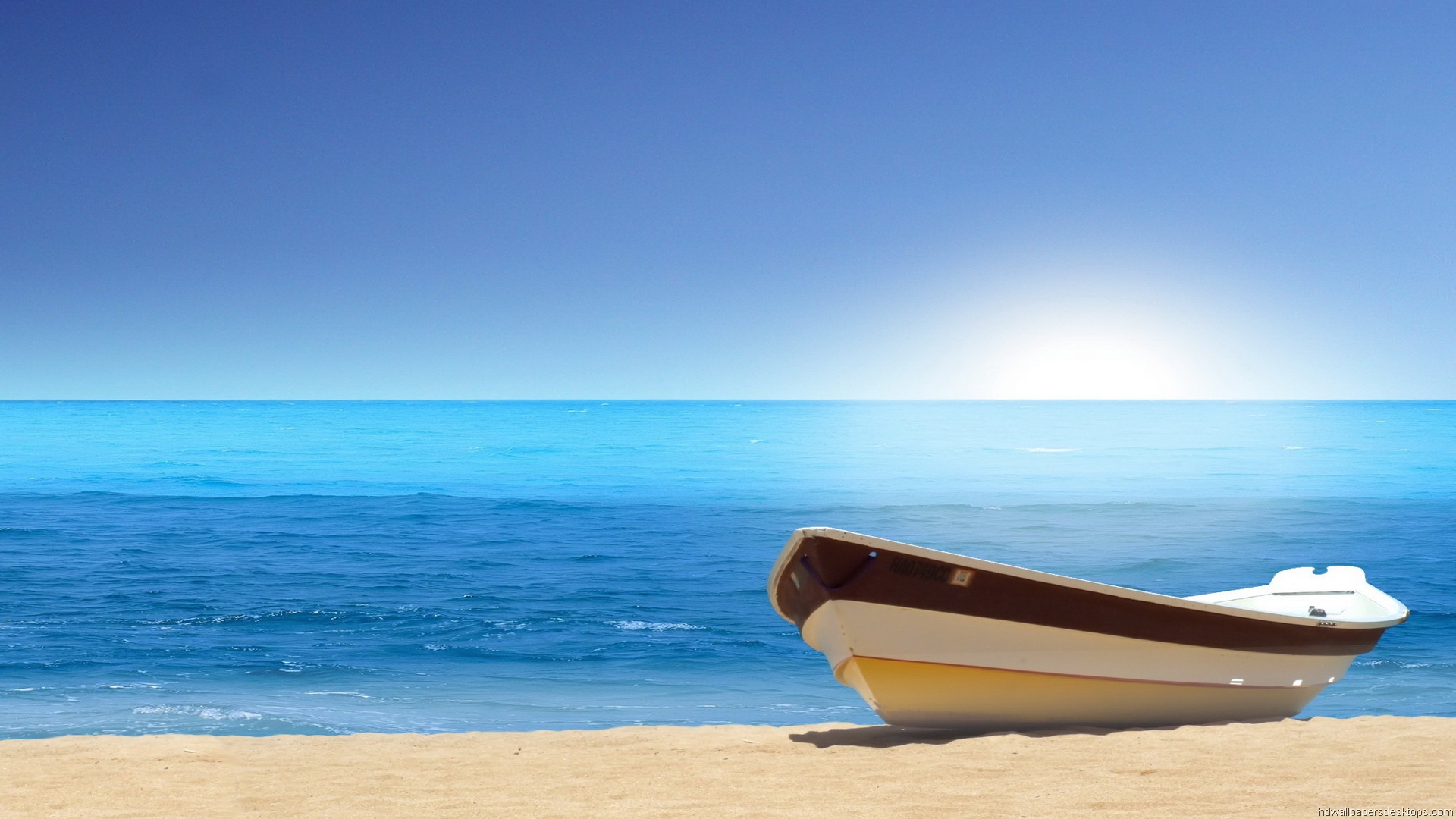 A serene beach scene with a small boat resting on the sand, overlooking the calm, turquoise sea under a clear blue sky. Perfect for sea and beach lovers