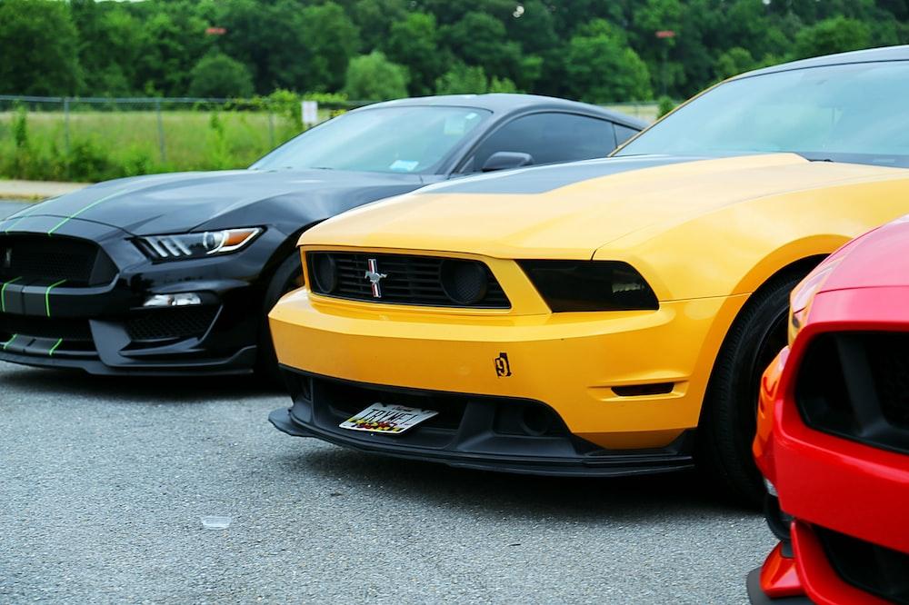 Parked Yellow Ford Mustang Coupe And Black Photo Car Image