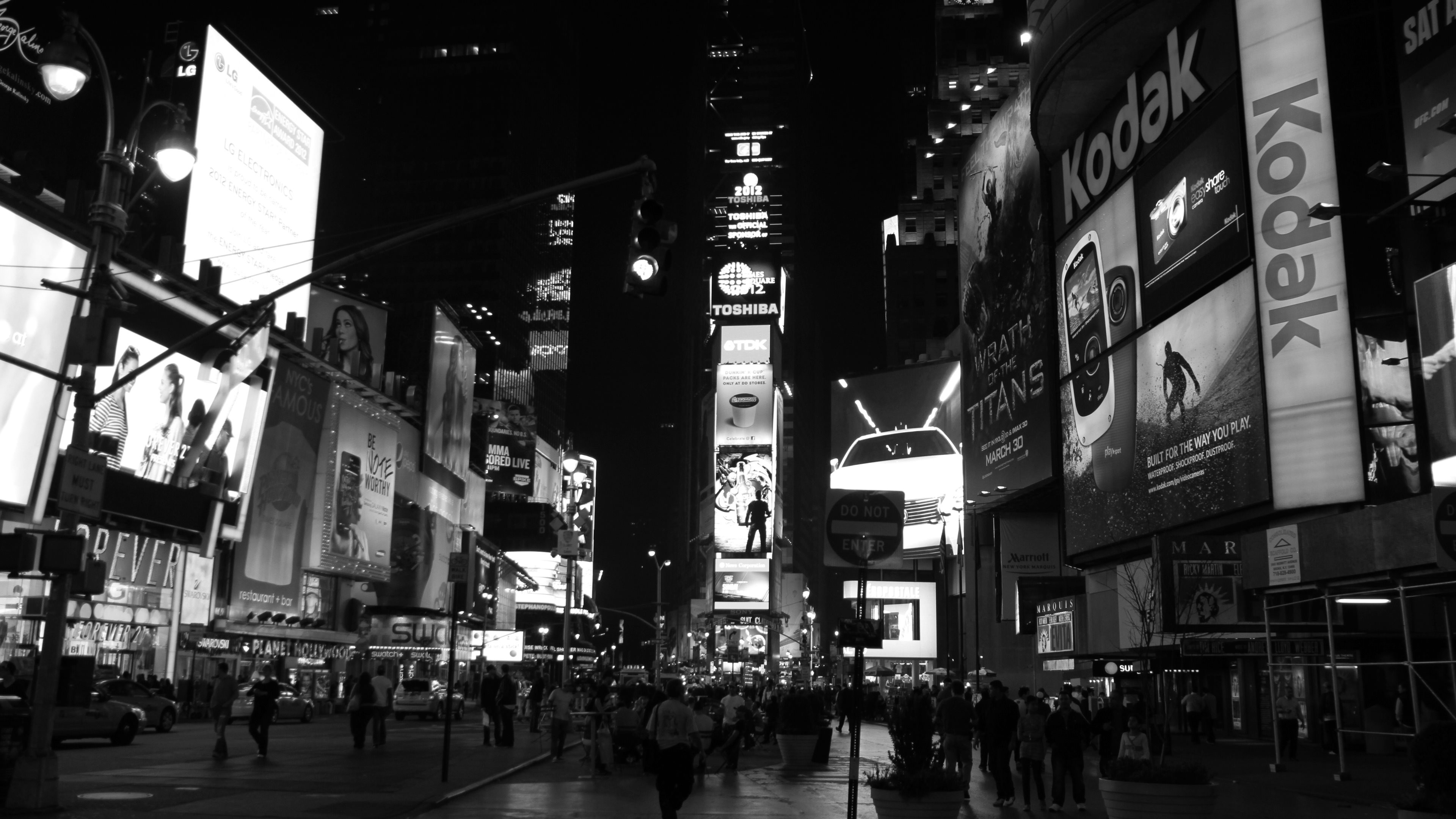 Black and white night view of Times Square in 4K, showcasing illuminated billboards and bustling crowds