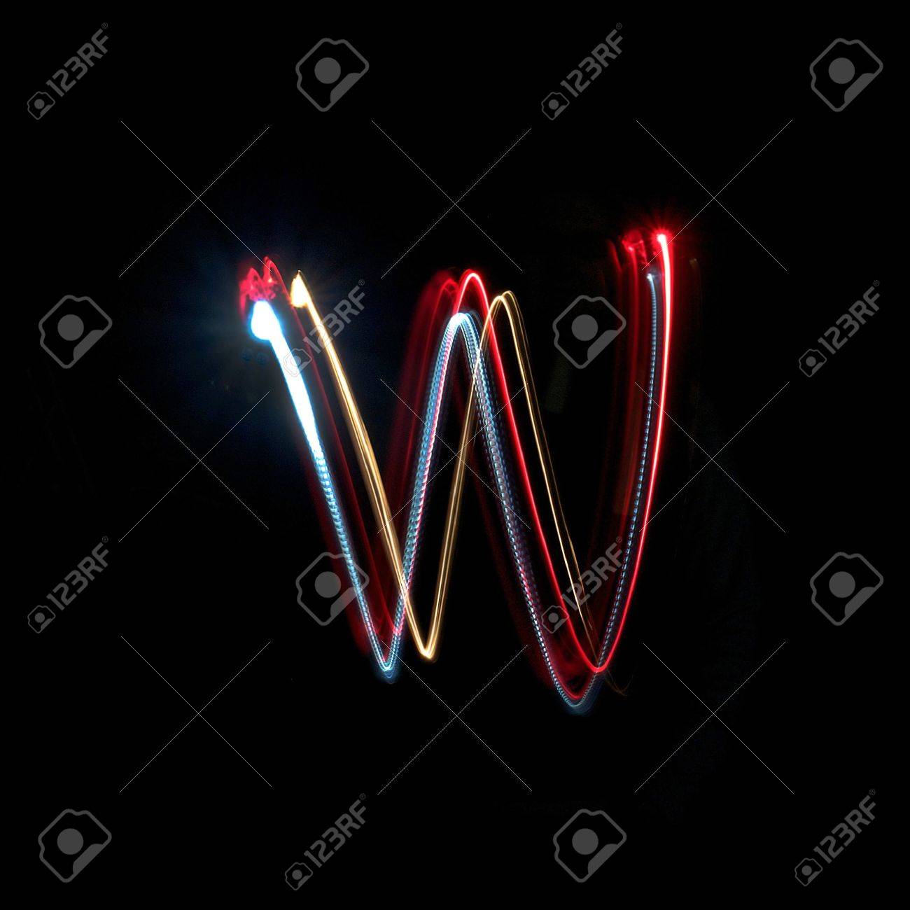 Letter W On A Black Background Made With Light Painting Torches