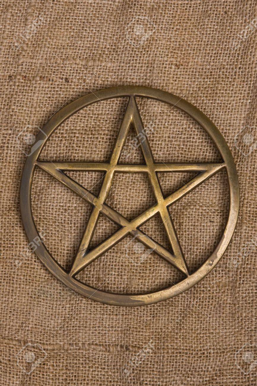 Close Up Of Brass Pentagram Pentacle On Burlap Hessian