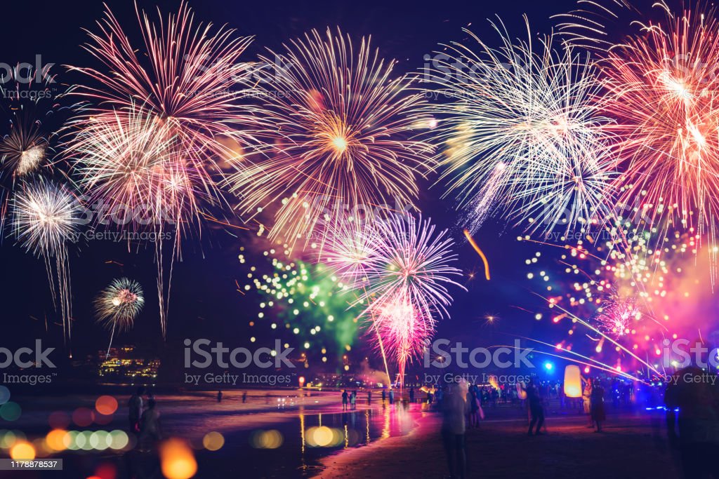 Fireworks With Silhouettes Of People In A Holiday Eventsnew Year