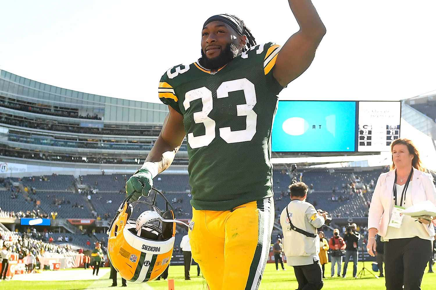 Green Bay Packers Aaron Jones Running The Ball In A Home Game Wallpaper