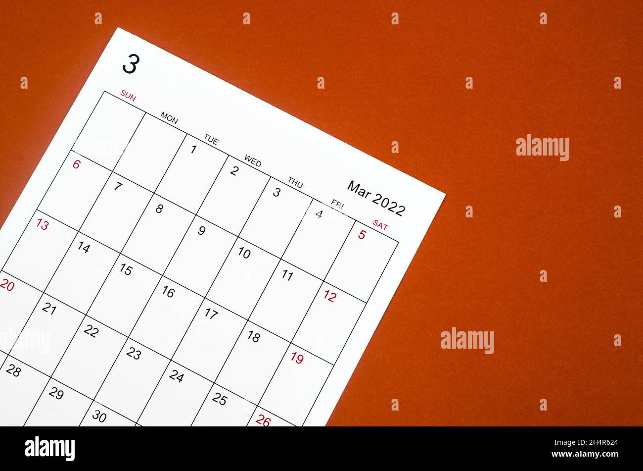 Close Up March Calendar Sheet On Red Background Stock Photo