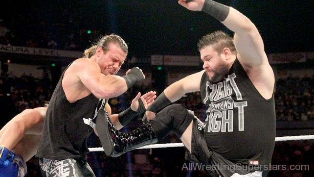 Kevin Owens Picking Dean Ambrose On His Shoulder