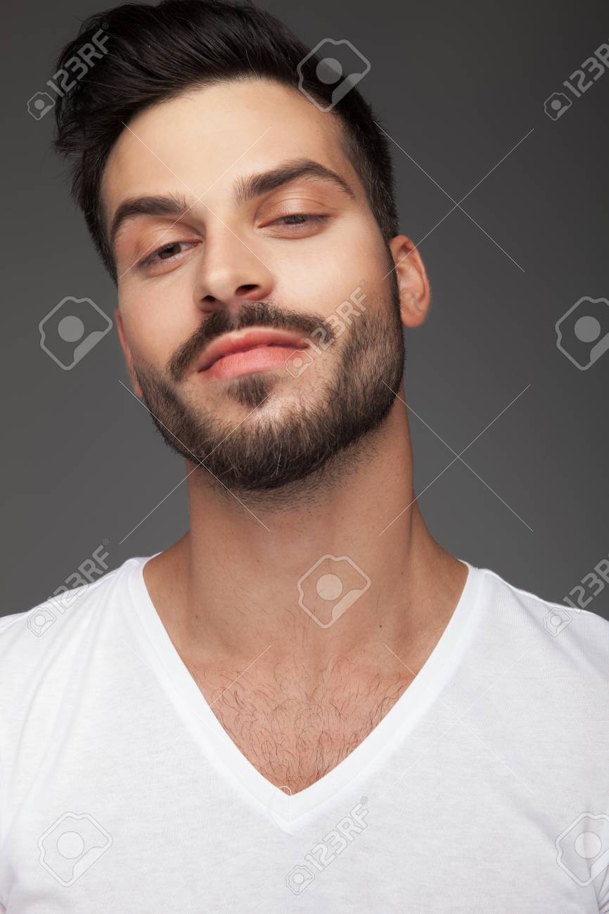 Smug And Arrogant Young Man Portrait On Grey Background Stock