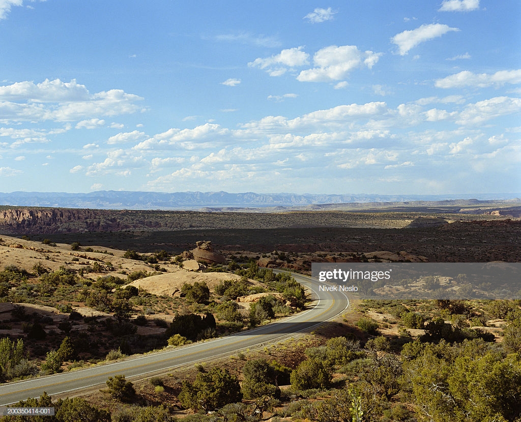 Usa Utah Near Moab Curving Road Mountains In Background Stock