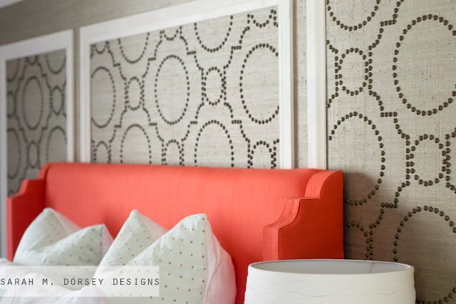The bright coral upholstered headboard adds a pop of color and the 640x427