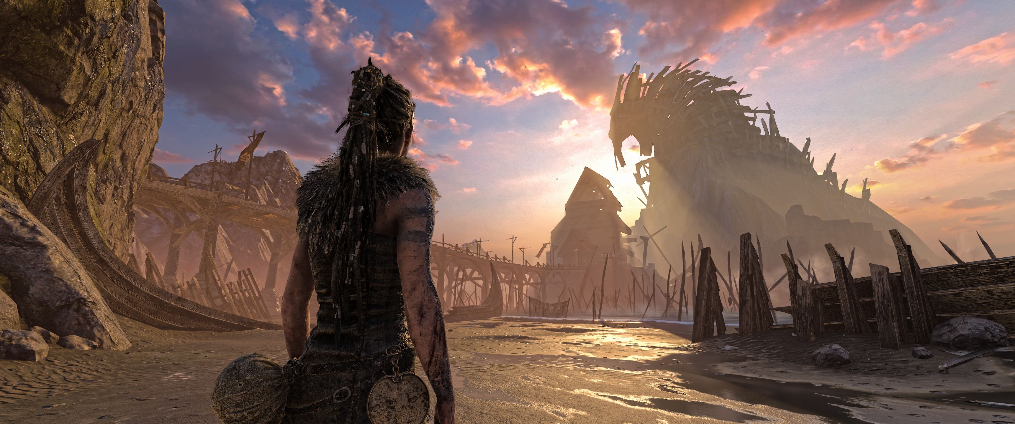 A 4K gaming wallpaper featuring a post-apocalyptic beach scene with a lone warrior and a large, skeletal creature in the background