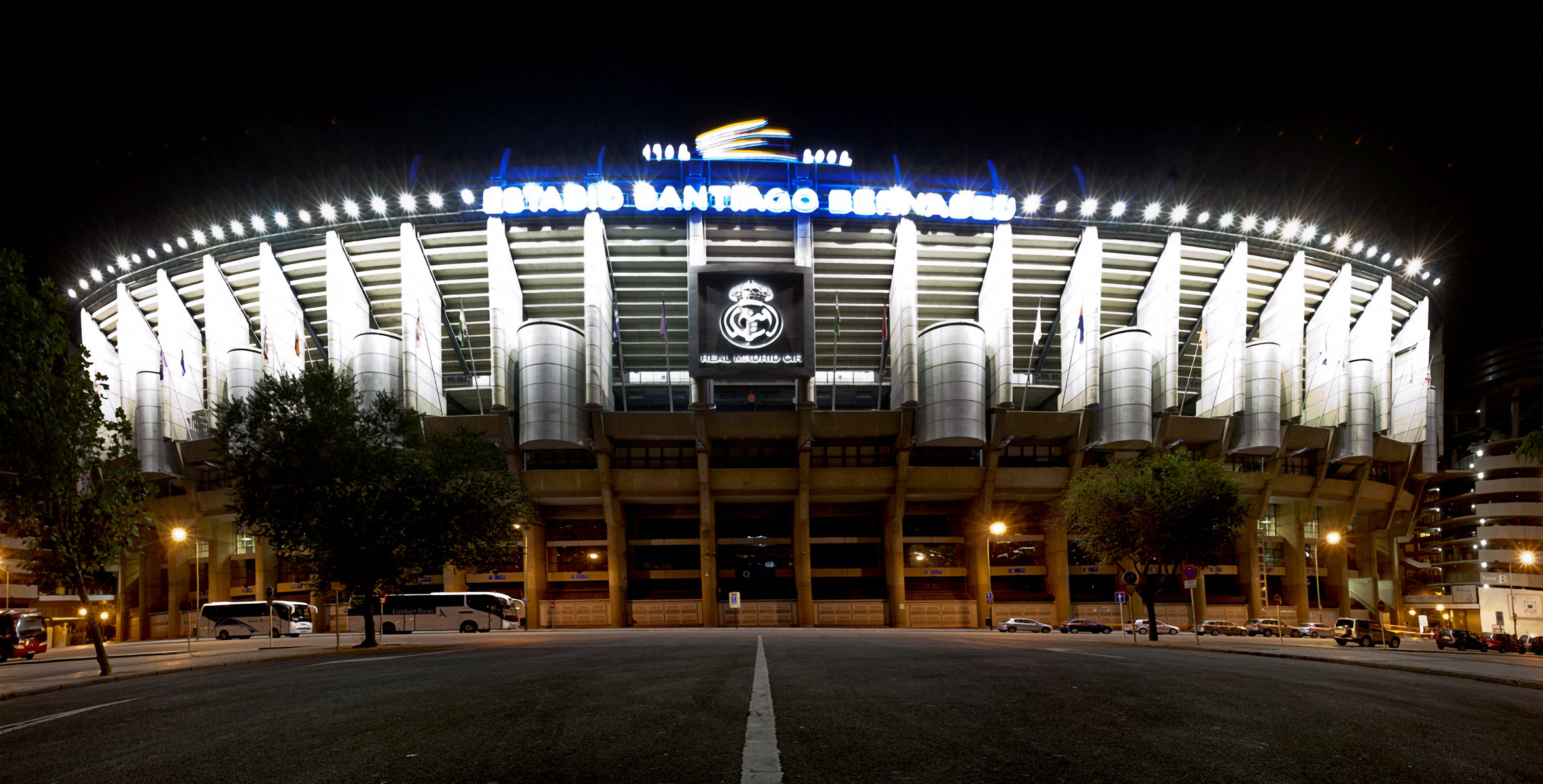 A stunning 4K night view of the Santiago Bernabéu Stadium, home of Real Madrid, illuminated against the dark sky