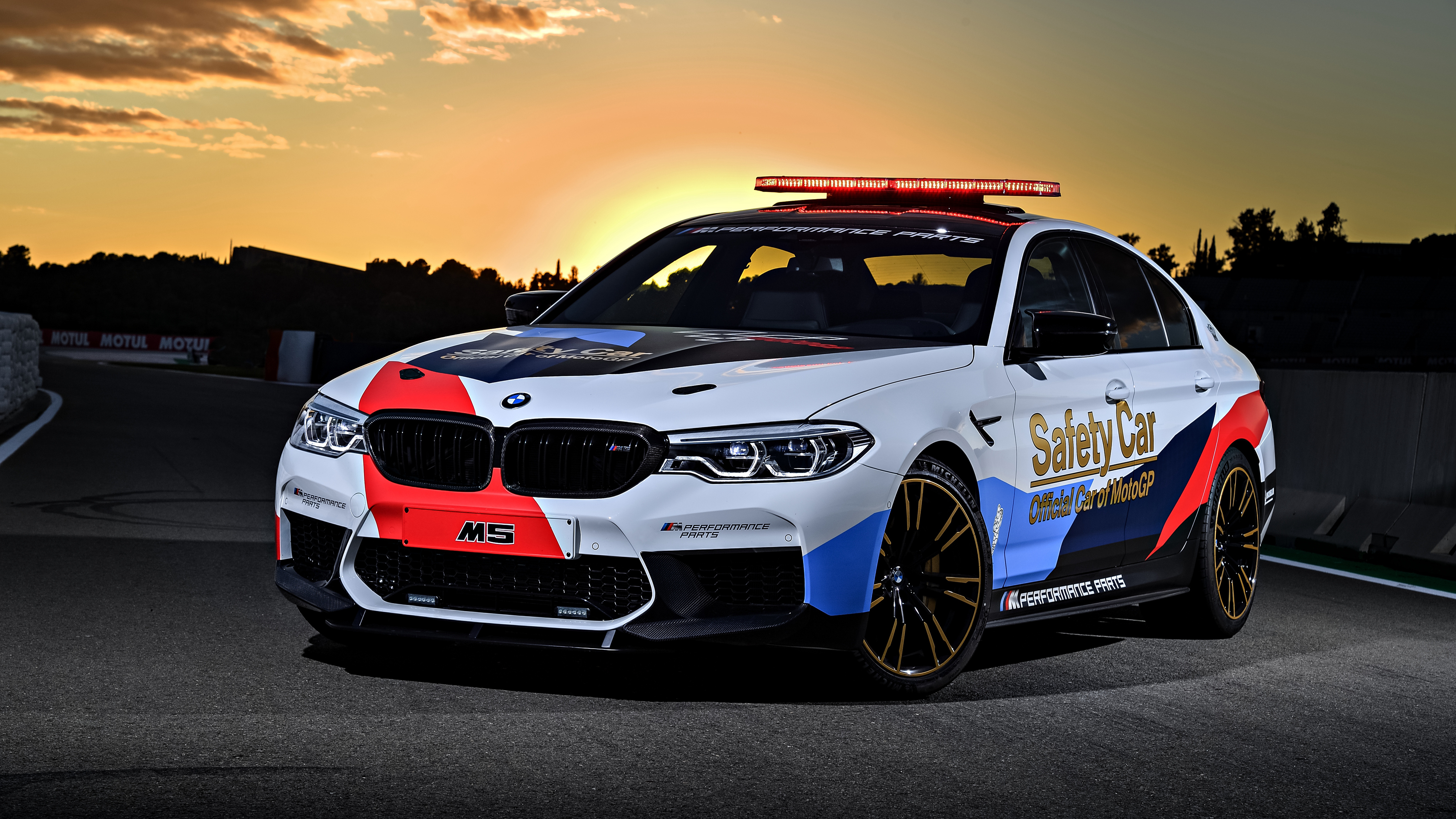 BMW M5 Safety Car on a racetrack at sunset