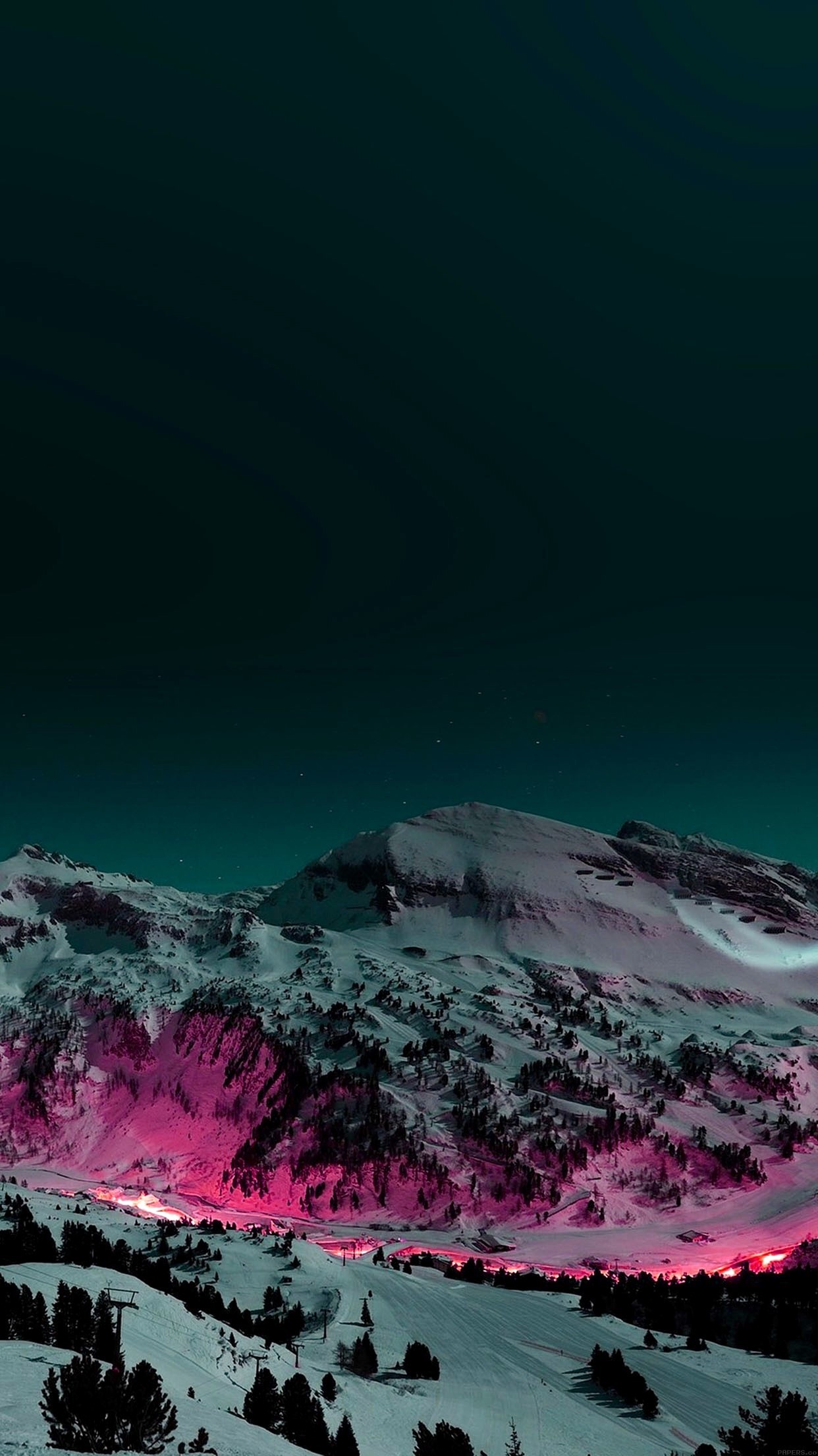 Pink-lit ski resort nestled in snow-capped mountains under a dark teal sky