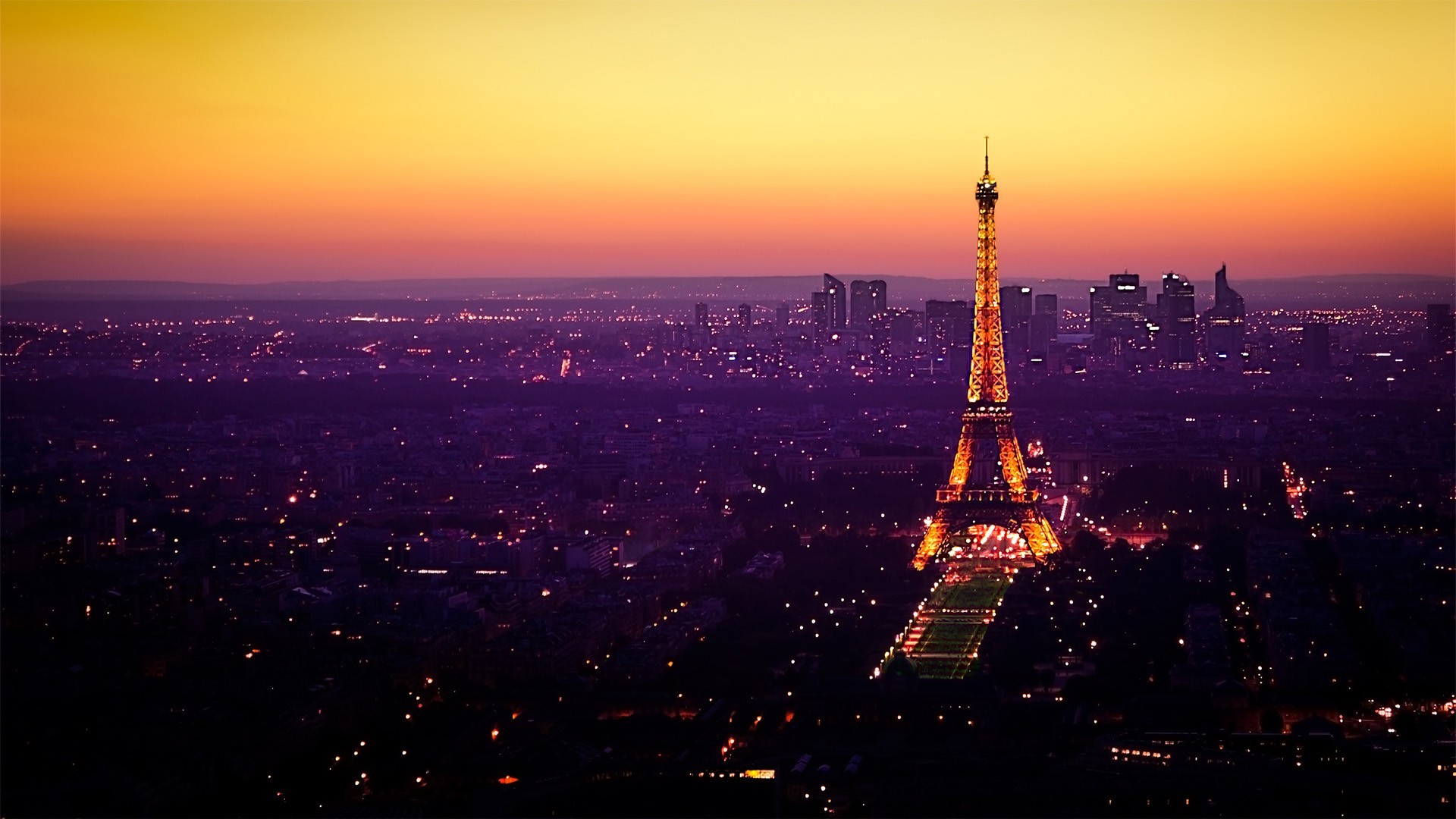 A breathtaking sunset view of the Eiffel Tower and Paris skyline at dusk