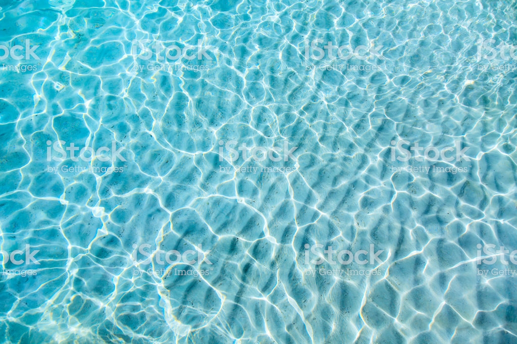 Blue Clear Transparent Water Background With Sand Stock Photo