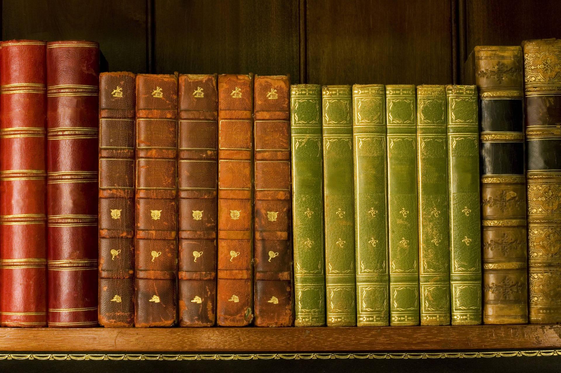Download Old books on a Library Shelf Wallpaper