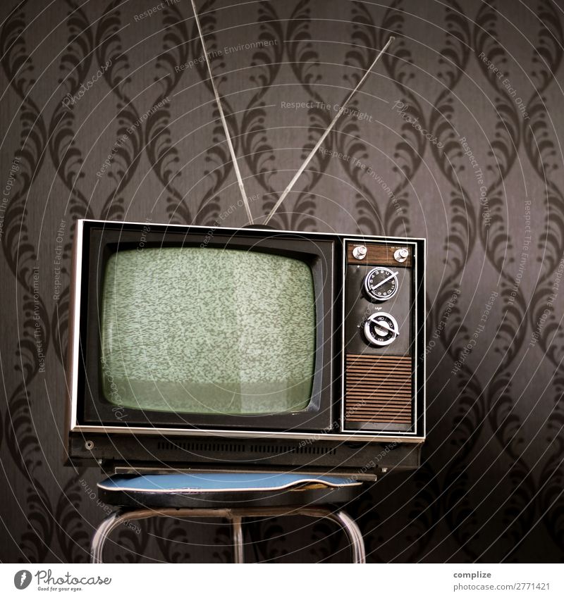70s Television Set In Front Of Vintage Wallpaper A Royalty