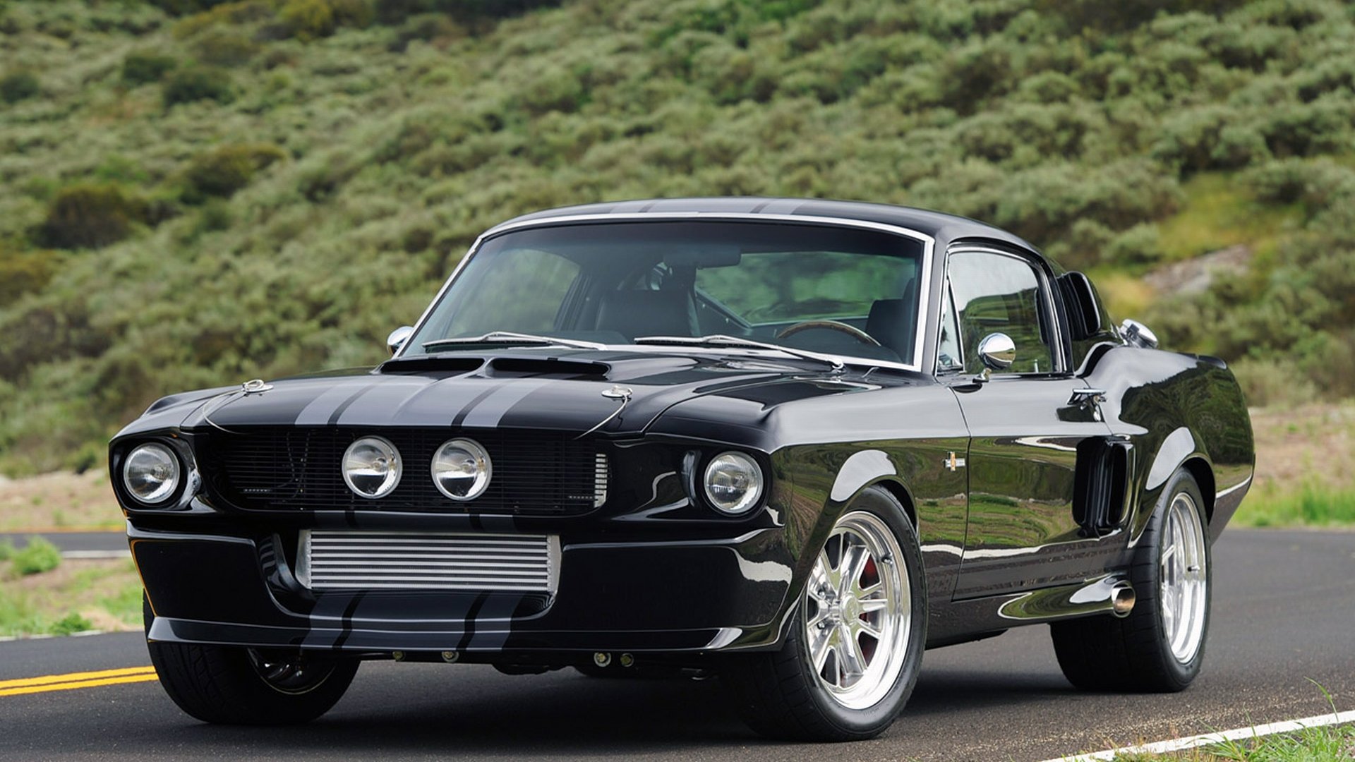 Classic Black Ford Mustang GT500 on a scenic road