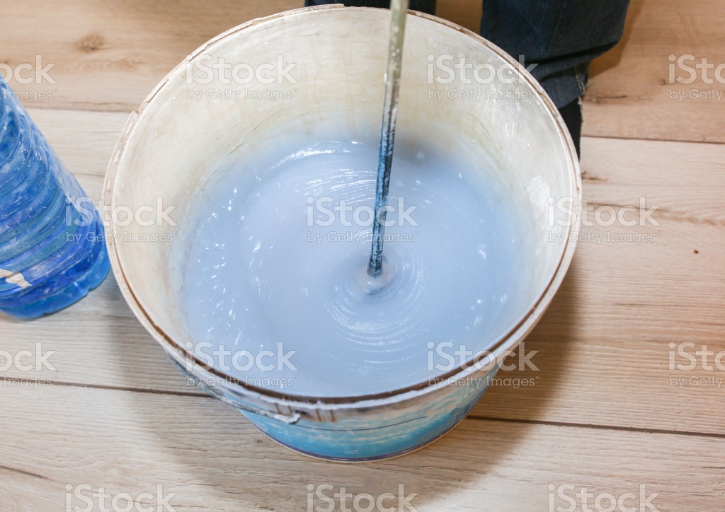 Man Is Mixing Spackling Glue In The Bucket Wallpaper Hanging In