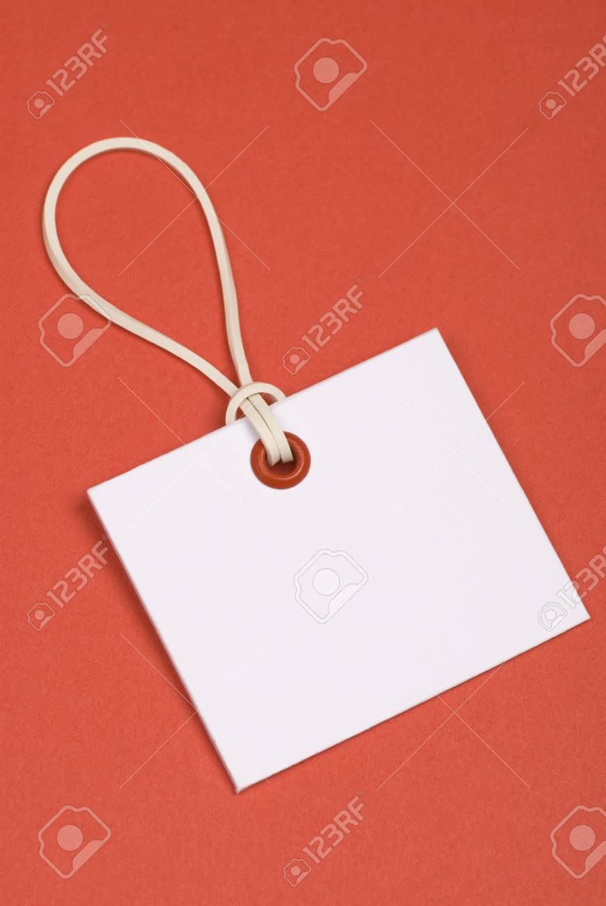 White Tag With Rubber Band Red Eyelet Paper Background Stock